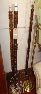 Lot 1160 - Three similar ring turned standard lamps;...
