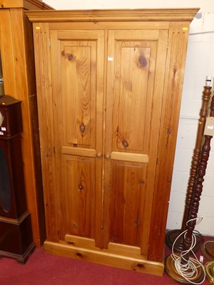 Lot 1161 - A modern pine double door wardrobe, w.109cm