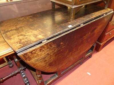 Lot 1204 - An 18th century joined oak dropleaf dining...