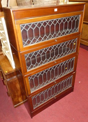 Lot 1207 - A 1930s walnut four-tier stacking bookcase by...