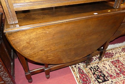 Lot 1212 - A walnut dropleaf table, having gateleg action