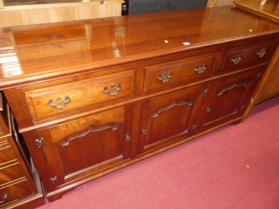 Lot 1225 - A joined cherry wood long sideboard, in the...