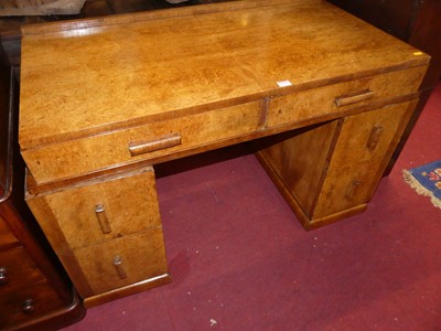 Lot 1252 - An Art Deco figured walnut twin pedestal...
