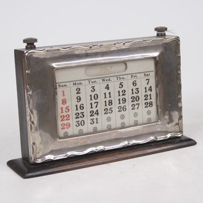 Lot 250 - A George V silver clad perpetual desk calendar,...