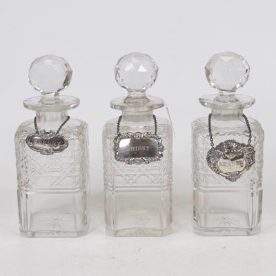 Lot 260 - A set of three cut glass decanters and...