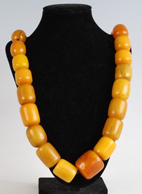 Lot 340 - A beaded amber necklace, comprising eight...