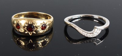 Lot 370 - A modern 9ct gold garnet dress ring, the three...