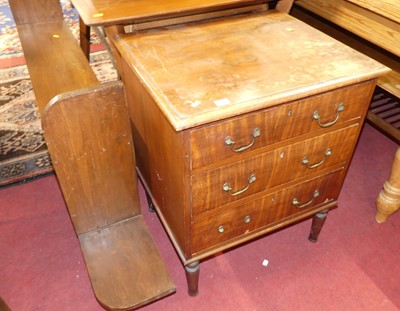 Lot 1271 - A walnut chest of three long drawers raised on...