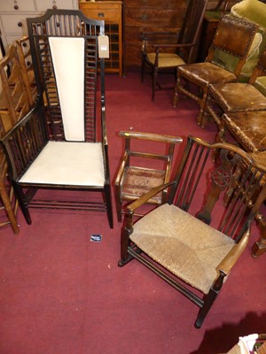 Lot 1293 - An Edwardian ebonised railed back armchair,...