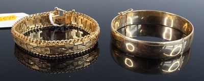Lot 378 - A 9ct gold and loaded hinged bangle, w.63mm;...