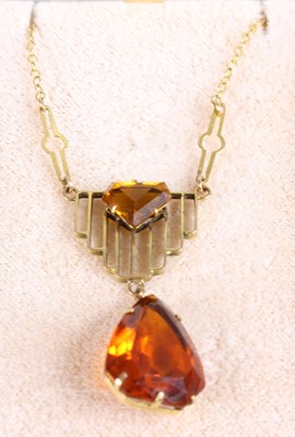 Lot 413 - An Art Deco yellow metal and orange paste set...