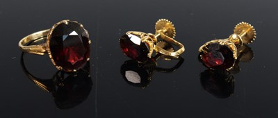 Lot 420 - An 18ct gold garnet set dress ring, the oval...