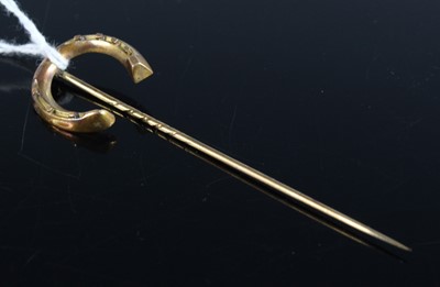 Lot 423 - A French yellow metal horseshoe tie-pin, in...