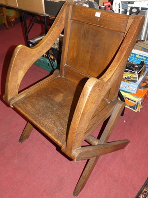 Lot 1334 - An early 20th century oak X-frame Glastonbury...
