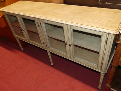 Lot 1336 - A contemporary limed and painted low four door...