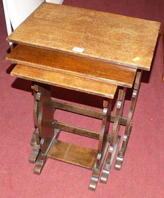 Lot 1325 - An oak nest of three occasional tables, the...