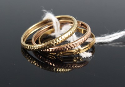 Lot 430 - A pair of 9ct yellow and rose gold band rings;...