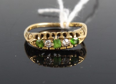 Lot 437 - An 18ct gold green garnet and diamond set five-...