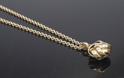 Lot 472 - A 9ct gold pendant fashioned as a ball of wool,...