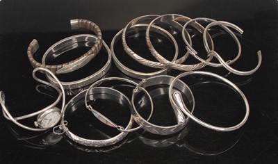 Lot 494 - A selection of silver and white metal bangles...