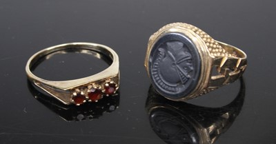 Lot 498 - A modern 9ct gold and garnet three-stone ring,...