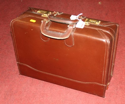 Lot 706 - A vintage brown leather briefcase, having twin...