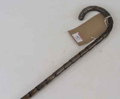 Lot 617 - An early 20th century stained bamboo walking...