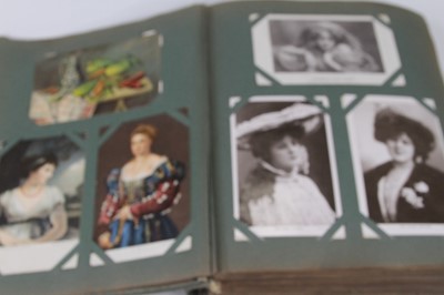 Lot 594 - An early 20th century postcard album,...
