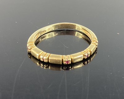 Lot 384 - A 14ct gold and ruby point set half hoop ring,...