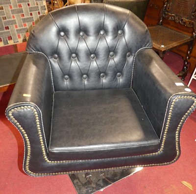 Lot 1351 - A black vinyl button back upholstered swivel...
