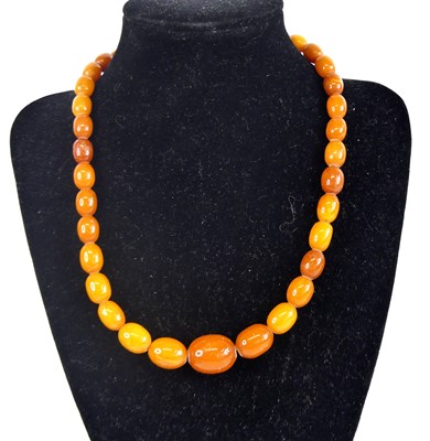 Lot 2503 - A single row of 37 graduated butterscotch...