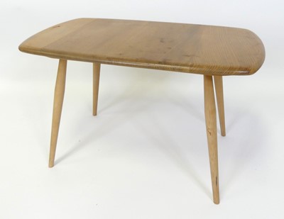 Lot 317 - An Ercol blond elm low occasional table, model...
