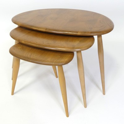 Lot 316 - An Ercol blond elm 'Pebble' nest of three...