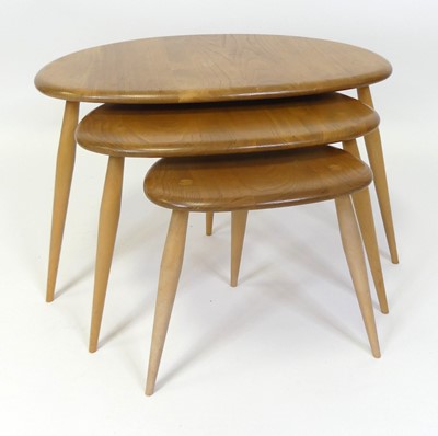 Lot 318 - An Ercol blond elm 'Pebble' nest of three...