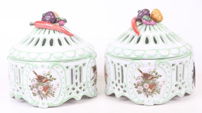 Lot 43 - A pair of porcelain pot pourri, each relief...