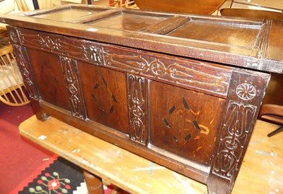 Lot 1300 - A joined oak and blind carved three panelled...