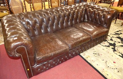 Lot 1332 - A chocolate brown leather buttoned upholstered...