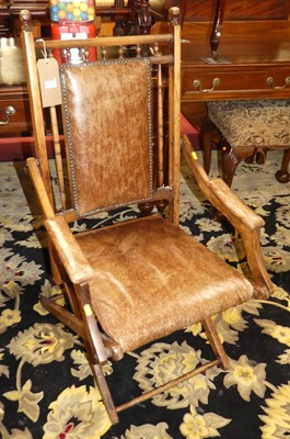 Lot 1344 - An early 20th century walnut, tan leather and...