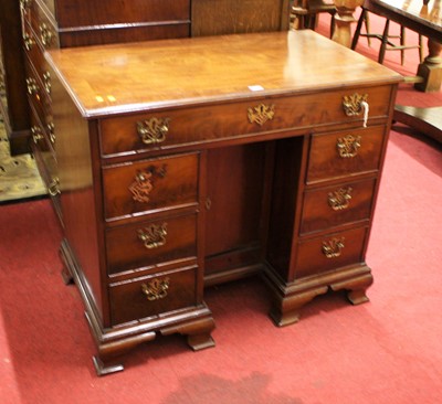 Lot 1353 - A George III mahogany kneehole desk, having a...