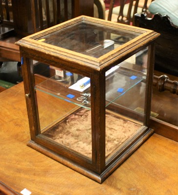Lot 1374 - An early 20th century oak table-top glazed...