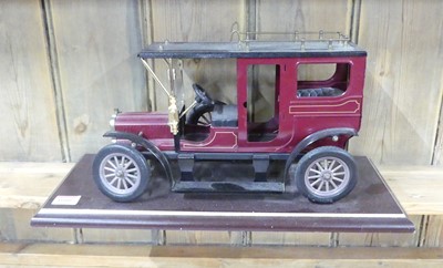Lot 1600 - A large scale tinplate pre-war car, on plinth