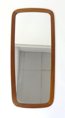 Lot 351 - A 1960s Danish teak wall mirror, having...