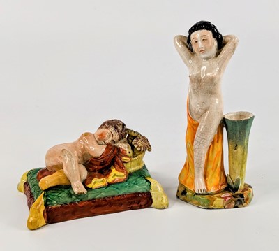Lot 1116 - A Staffordshire pearlware figure of a sleeping...