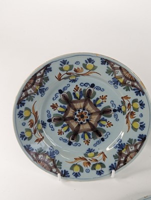 Lot 1101 - A set of four Lambeth polychrome delftware...