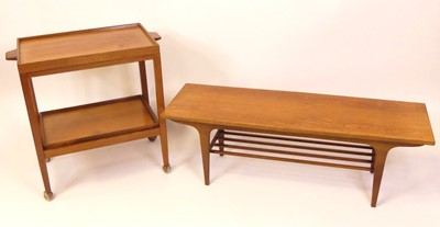 Lot 365 - A 1970s teak two-tier tea trolley, having...