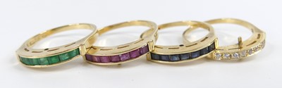 Lot 2630 - Four yellow metal multi-stone stacking rings,...