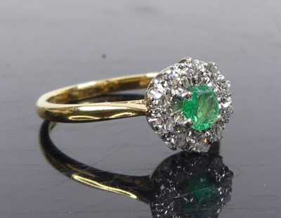 Lot 2632 - A yellow and white metal, emerald and diamond...