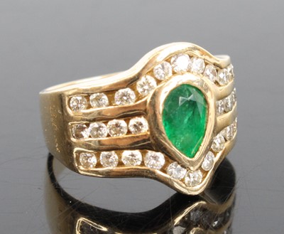 Lot 1304 - A 14ct yellow gold emerald and diamond dress...