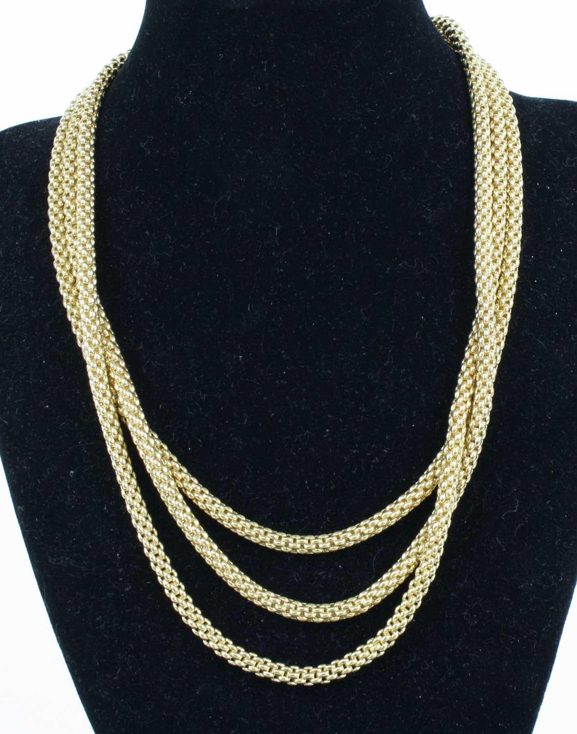 Lot 1309 - A Fope 18ct yellow gold three-strand meshlink...