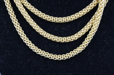 Lot 1309 - A Fope 18ct yellow gold three-strand meshlink...
